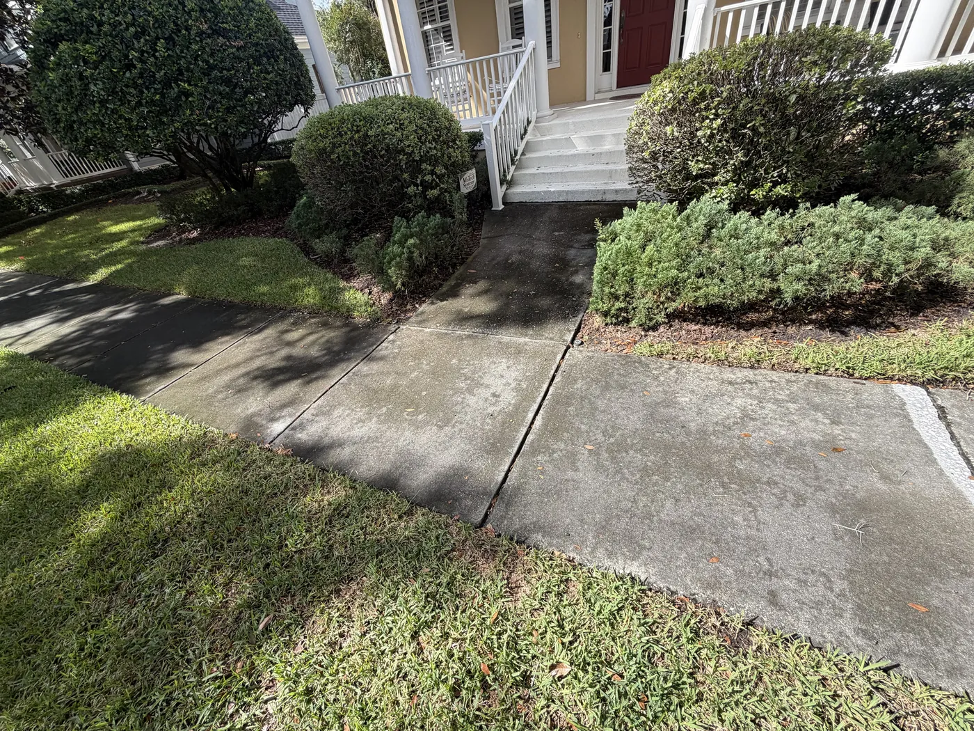 Before: concrete sidewalk and front walkway darkened by mildew in Baldwin Park, Orlando