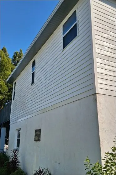 After: two-story house soft wash by Waddle Works
